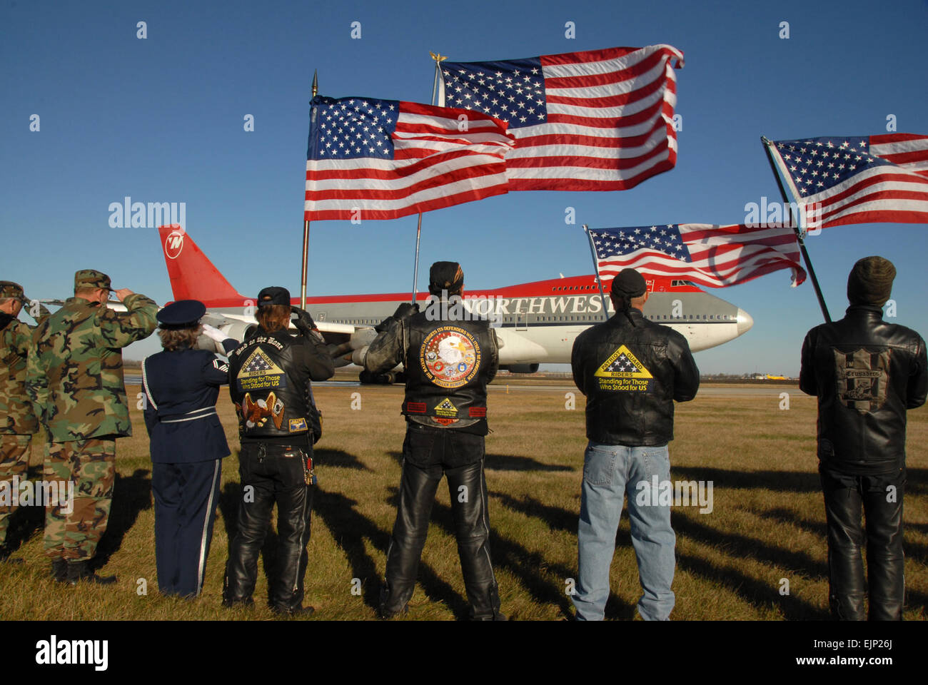 Von links North Dakota Air Nationalgardisten, Patriot Guard Motorrad Fahrer und North Dakota Armee Nationalgardisten Gruß und stehen stramm wie ein Flugzeug mit Veteranen nach Washington zog sich zurück, um die National World War II Memorial tour fährt Hector International Airport in Fargo, ND, 2. November 2007. US Air Force Senior Master Sergeant David H. Lipp veröffentlicht Stockfoto