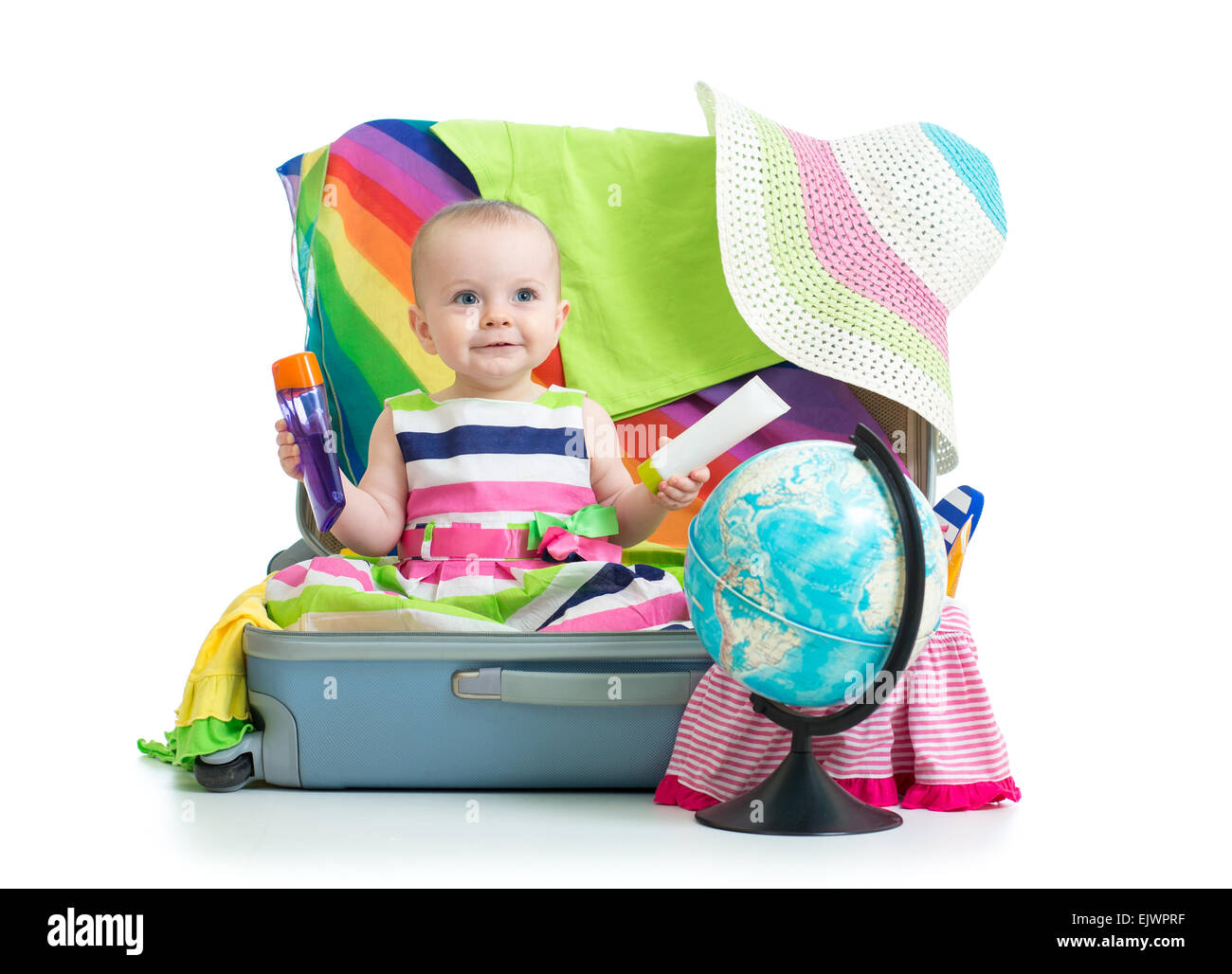 Babymädchen sitzen im Koffer mit Dingen für Urlaubsreisen Stockfoto