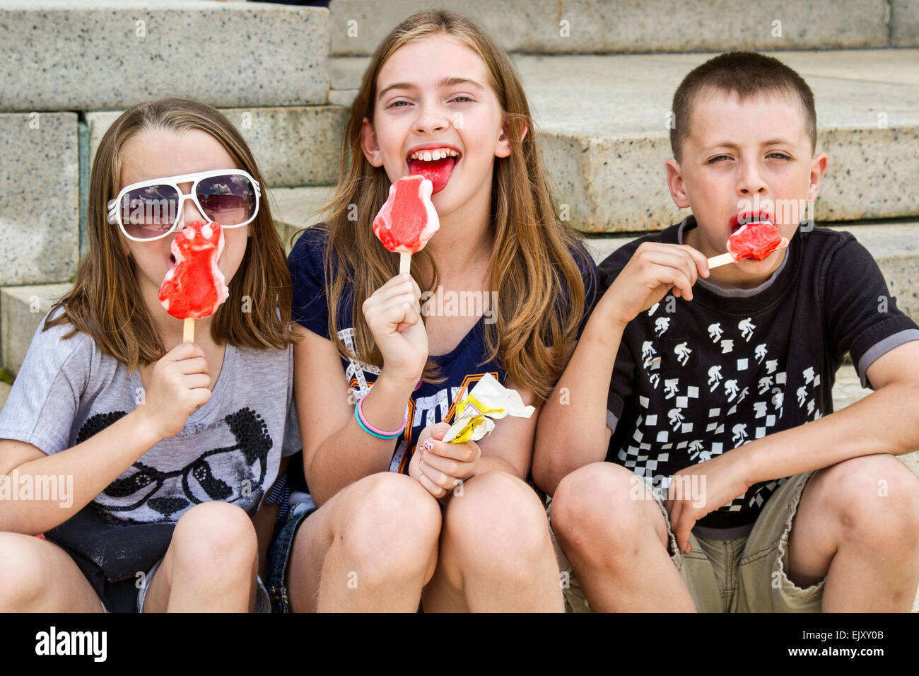 Drei Kinder freuen sich über Eis Stockfoto