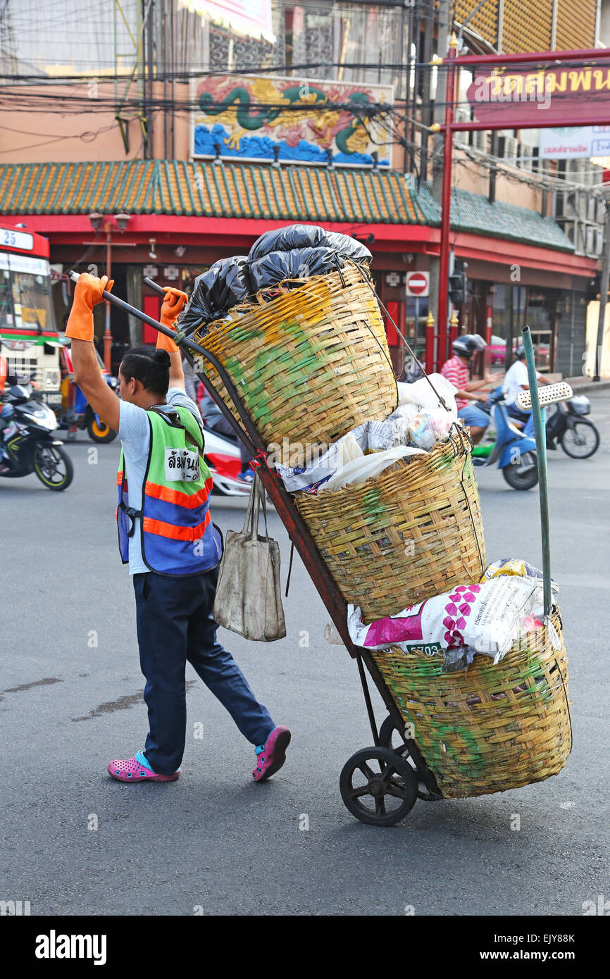 Arbeiter tragen Körbe von Produkten auf der Straße in Chinatown in Bangkok, Thailand Stockfoto