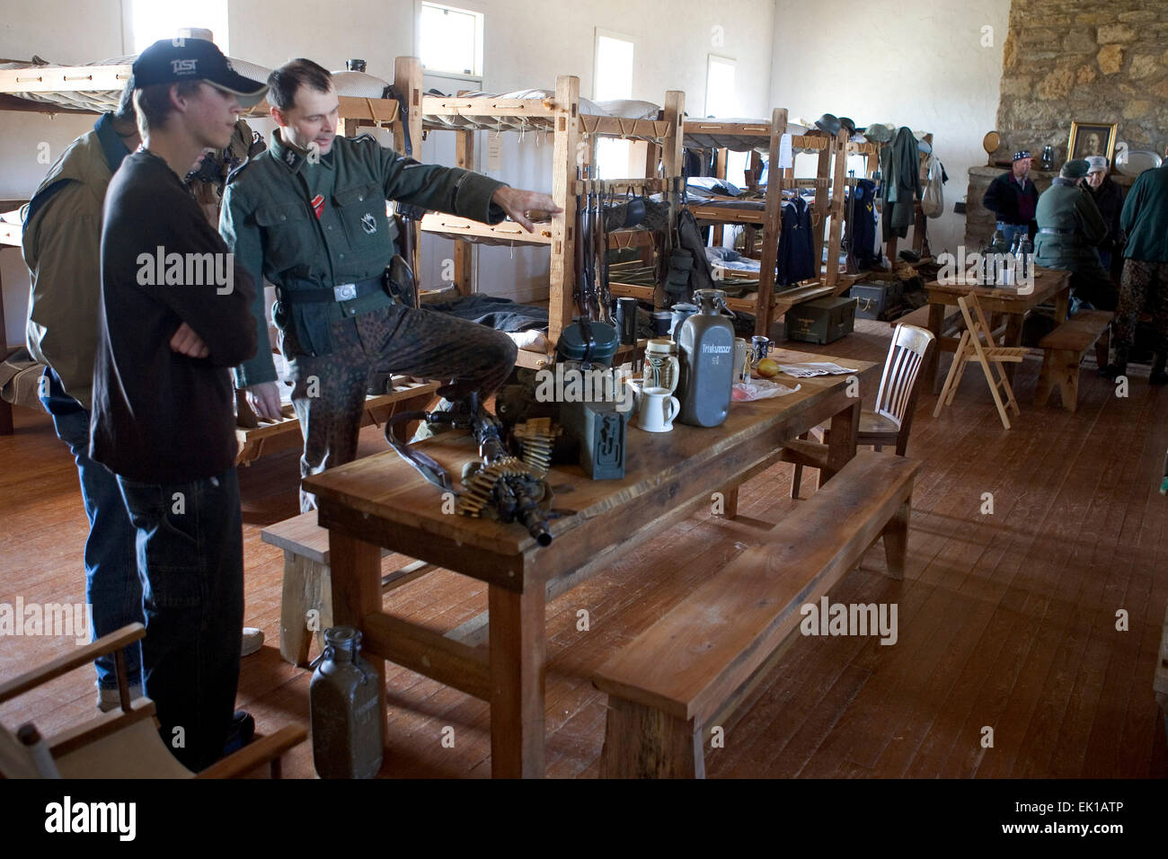 Eine Waffen-SS-Reenactor gibt Erklärungen über Geräte und Ausrüstungen für Besucher im Inneren einer Baracke während einer Versammlung eine Fort-Wasshit Stockfoto