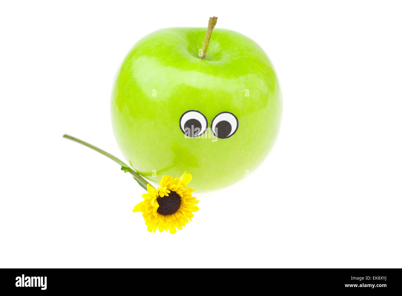 Apfel mit Augen und eine Blume isoliert auf weiss Stockfoto