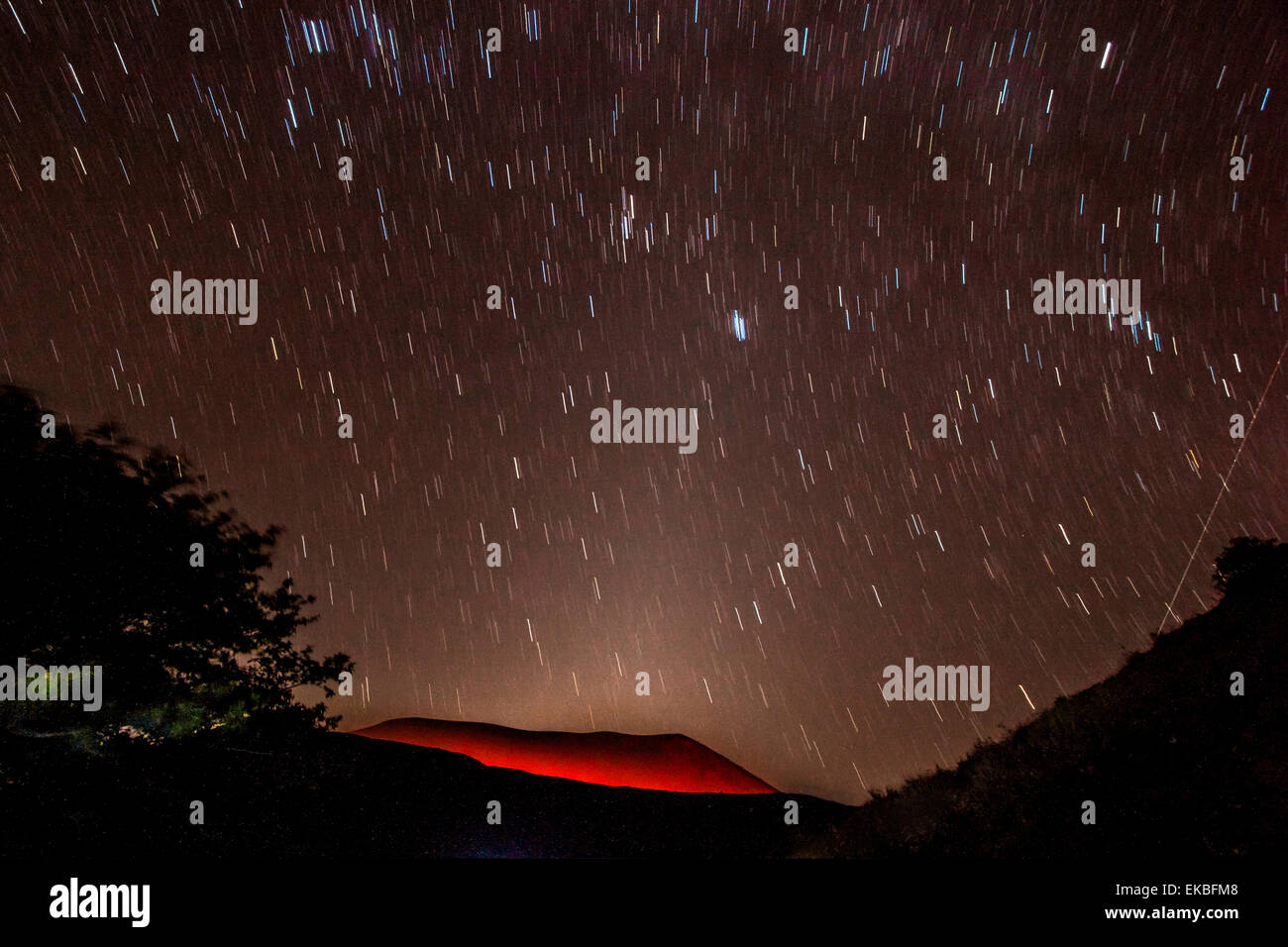 Glühende aktiven Vulkankrater des Volcan Telica nachts mit Sternspuren und Shooting Star (Meteor) rechts, Leon, Nicaragua Stockfoto