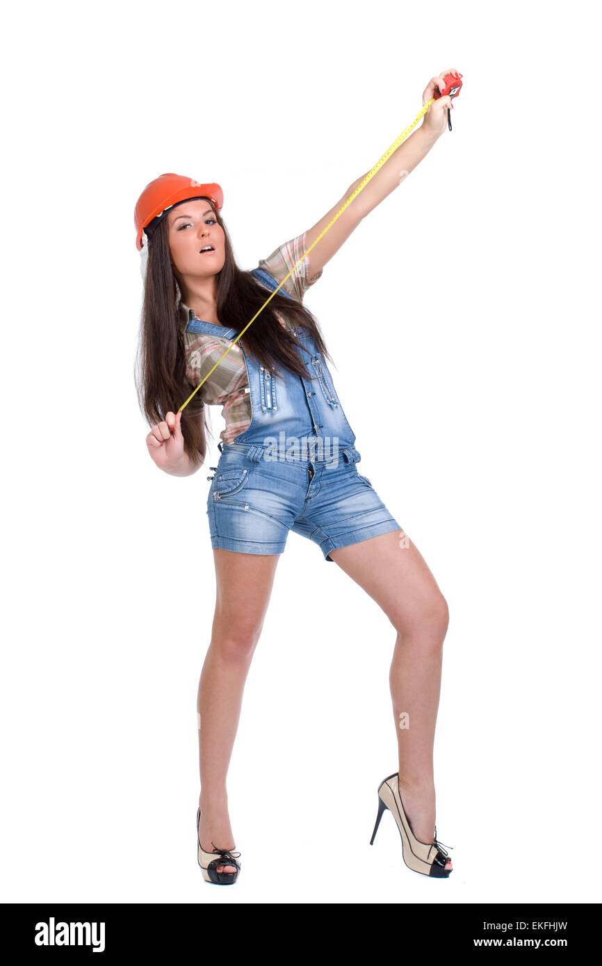 Junge Frau in orange Helm mit Maßband Stockfoto