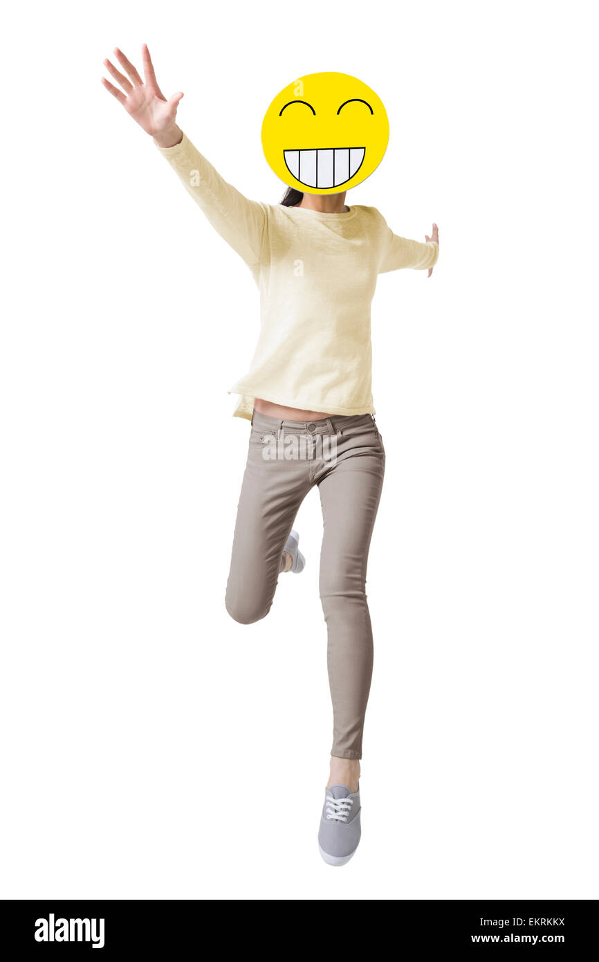 Junge Frau mit einem glücklichen Smiley Gesicht vor ihr Gesicht läuft Stockfoto