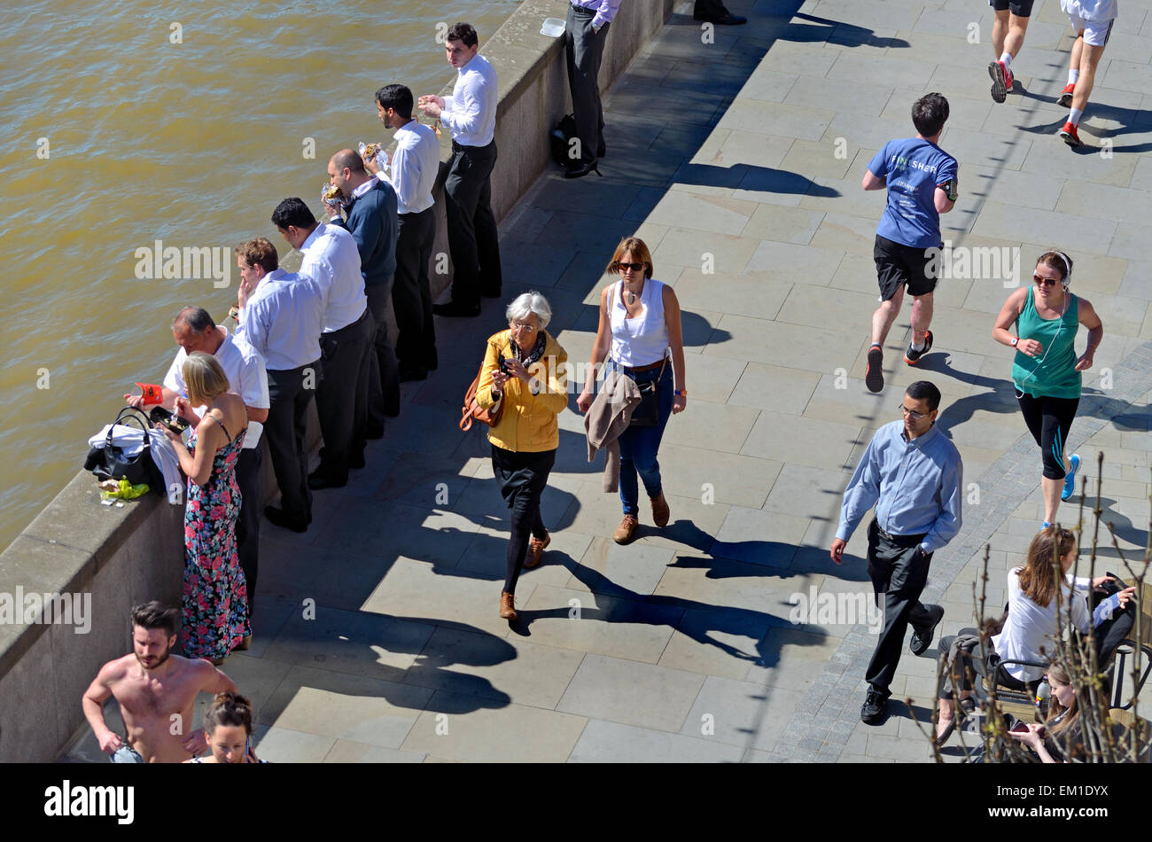 London, England, Vereinigtes Königreich. Stadtarbeiter beim Mittagessen außerhalb an der Themse am wärmsten Tag des Jahres so weit (14.04.2015) Stockfoto
