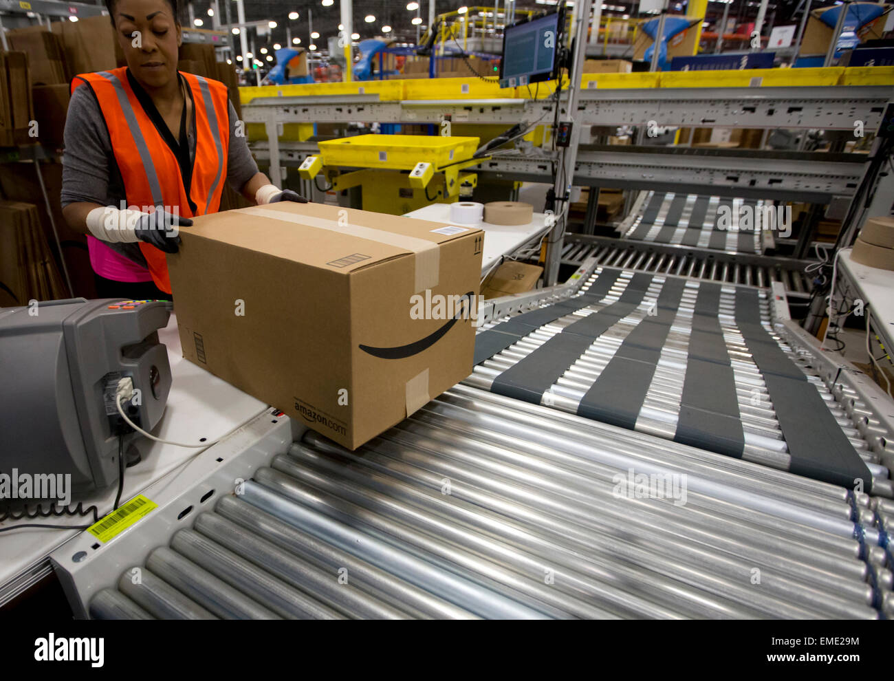 African-American Arbeitnehmerin Pakete Elemente in Boxen bei Amazon Fulfillment-Center in Texas Stockfoto