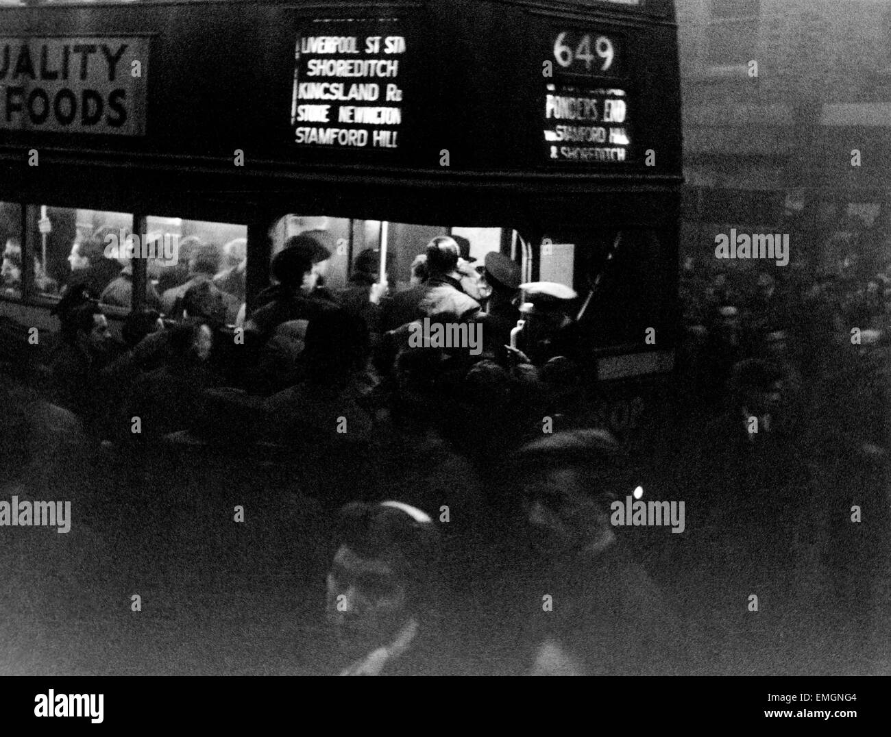Pendler Schwarm an einem Bus Nr. 649 in Tottenham an einem düsteren Winter-Abend. 21. November 1945 Stockfoto