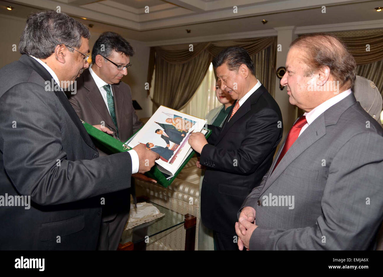 Prinzipal Information Officer, Rao Tehsin Ali präsentiert Foto-Album auf chinesischen Staatspräsidenten Xi Jinping bei seinem Abschied auf Nur Khan Air Base in Islamabad am Dienstag, 21. April 2015. Stockfoto