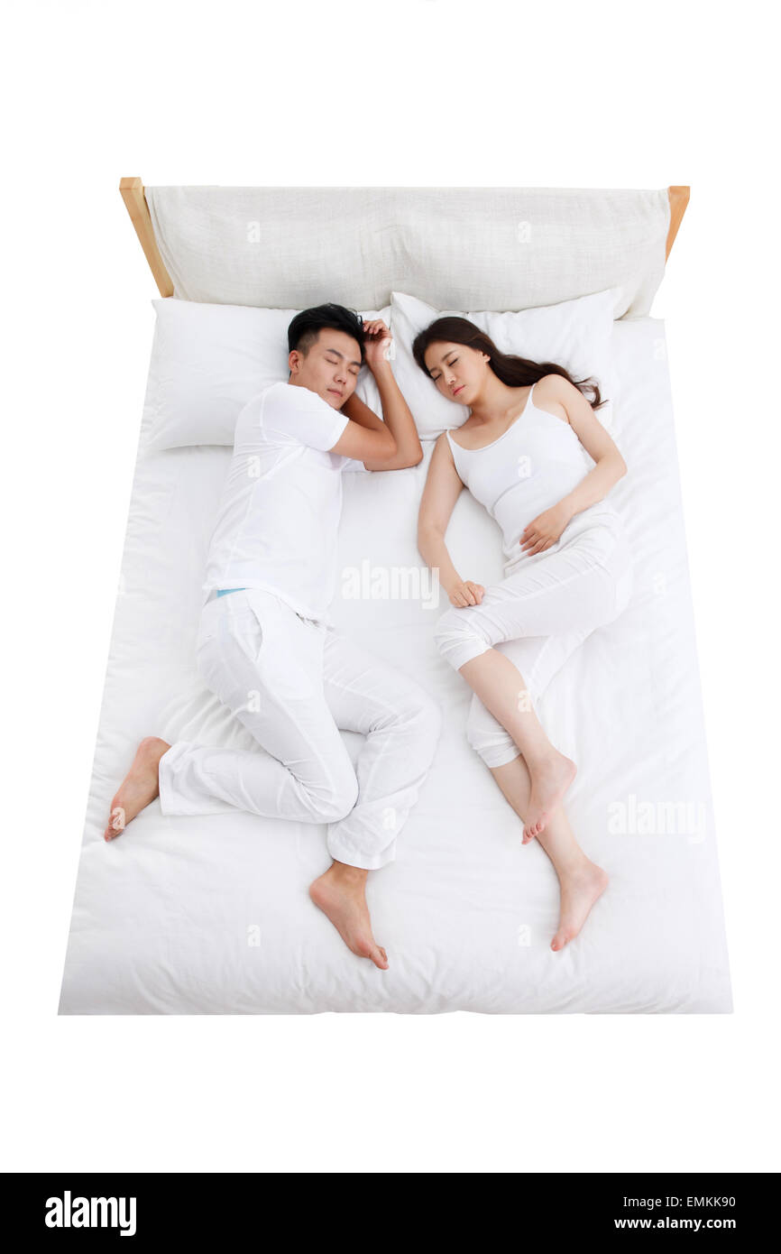 Das junge Paar schlafen im Bett der Schlafzimmer Stockfoto