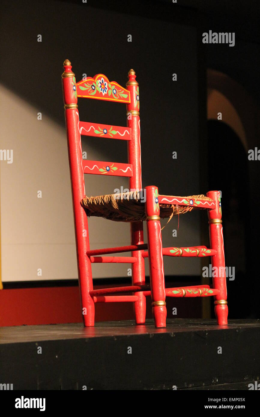 Spanisch-andalusischer roter Schaukelstuhl, in traditionellem Stil  gestrichen und dekoriert. Typische Stühle, die in den berühmten 'Casetas'  des April verwendet werden Stockfotografie - Alamy