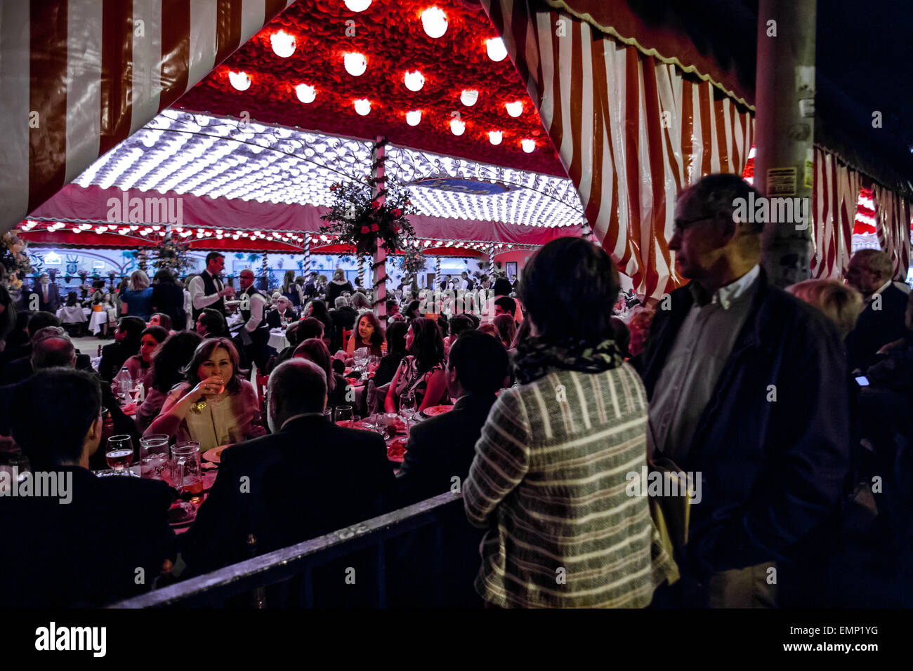 Zwei Personen schauen Sie sich das Innere des Messestandes auf der "Feria de Abril", Sevilla, Spanien, 21. April 2015. Stockfoto