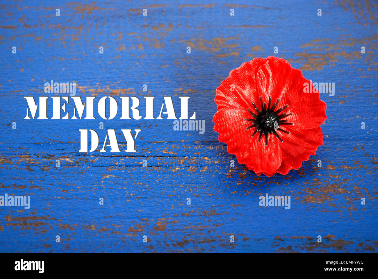 USA Memorial Day Konzept der rote Erinnerung Mohn auf dunklen blau Vintage distressed Holztisch mit Titeltext. Stockfoto