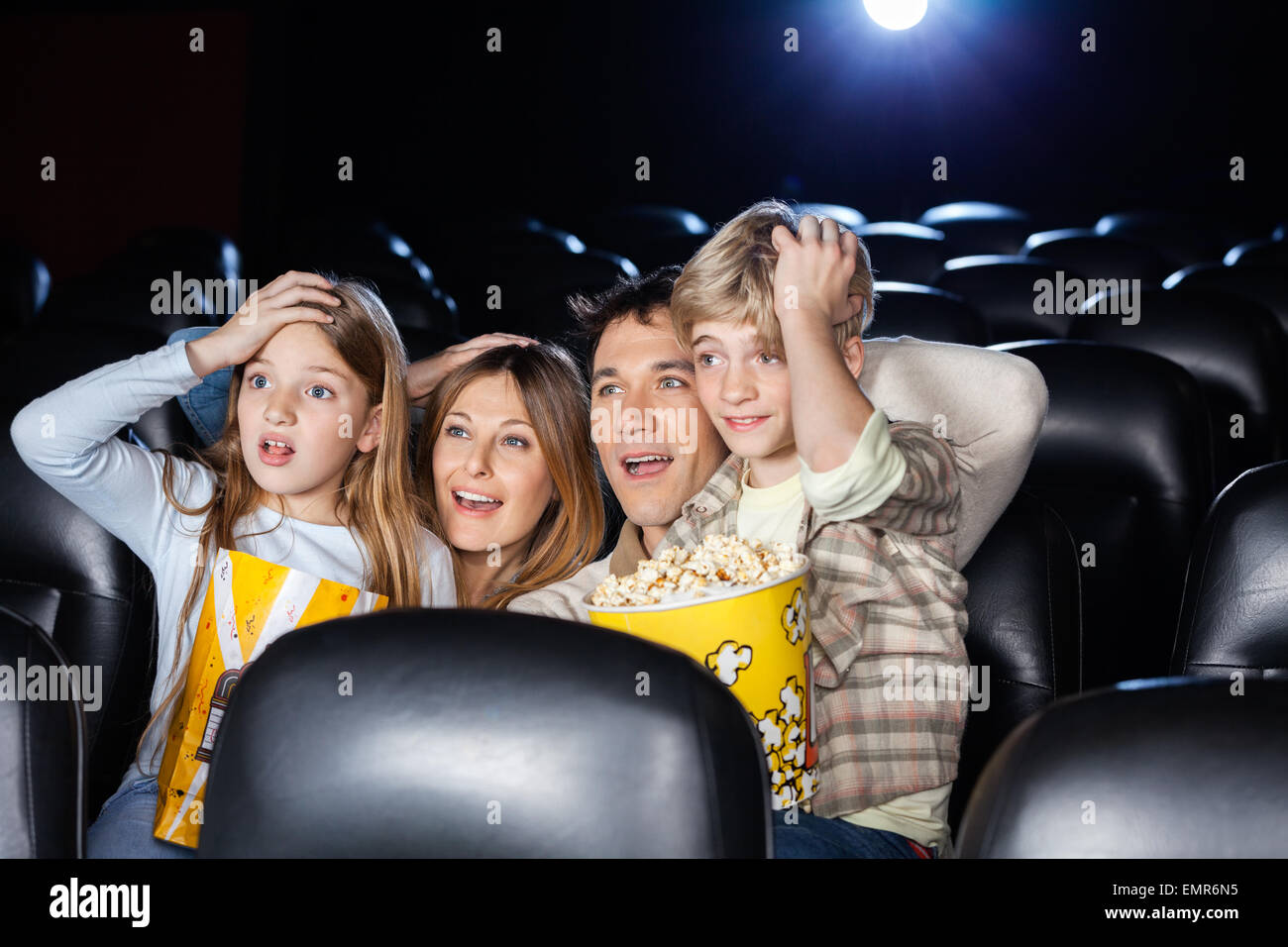 Erstaunt beobachtete Familienfilm im Kino-Theater Stockfoto