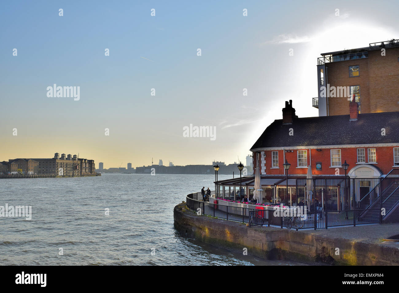 Blick auf die Themse, geht die Sonne über London mit der schmalen Gastro-Pub im Vordergrund Stockfoto