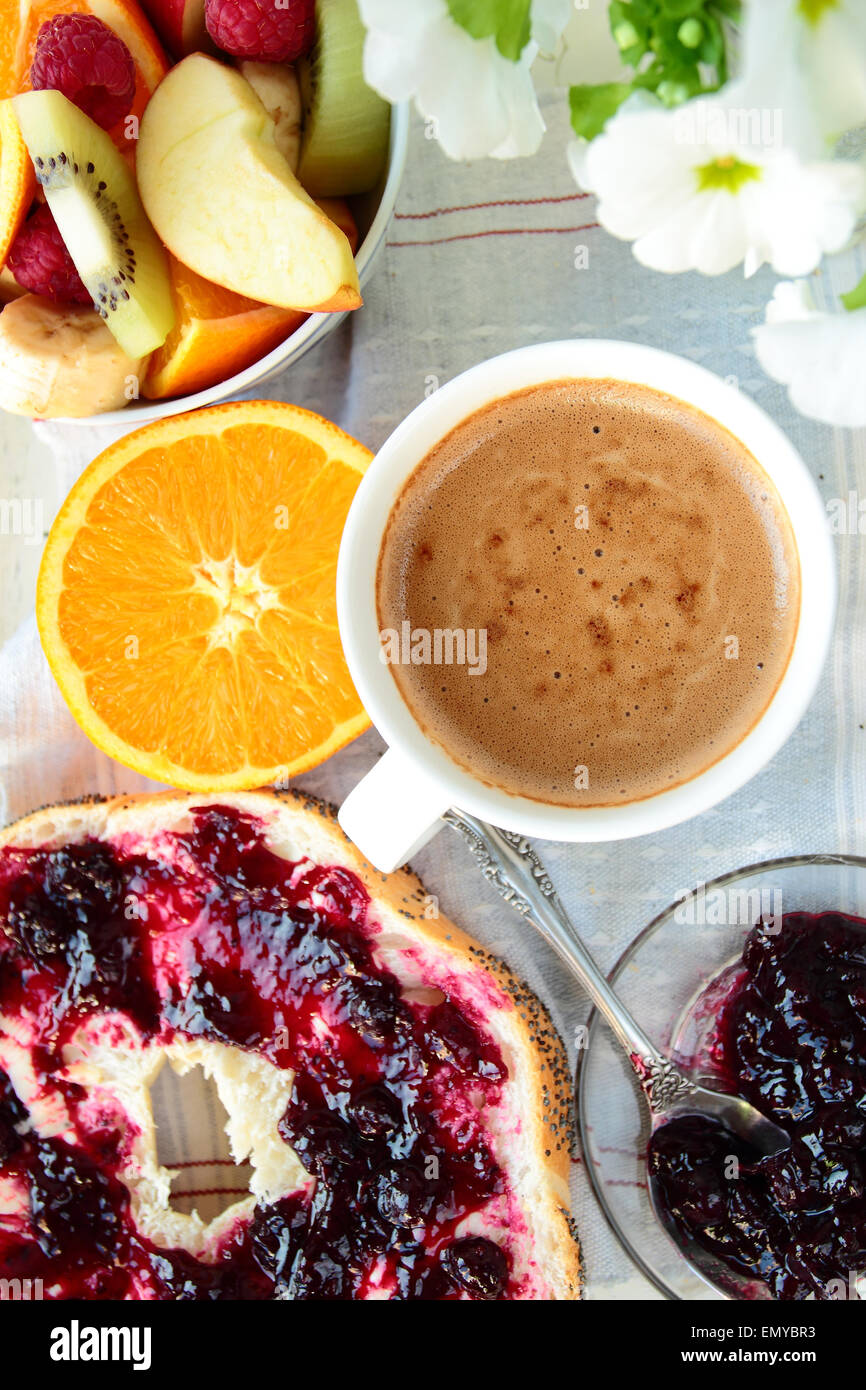 Brötchen Sie mit Marmelade, in Scheiben geschnittene Orange und Kaffee zum Frühstück Stockfoto