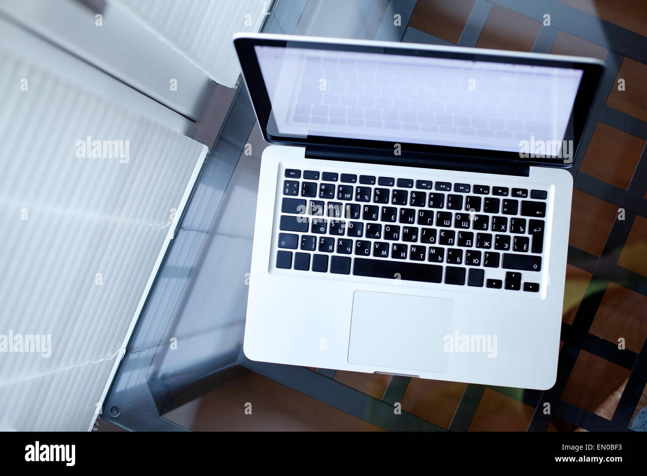 Draufsicht der Laptop auf Glastisch im modernen Interieur Stockfoto
