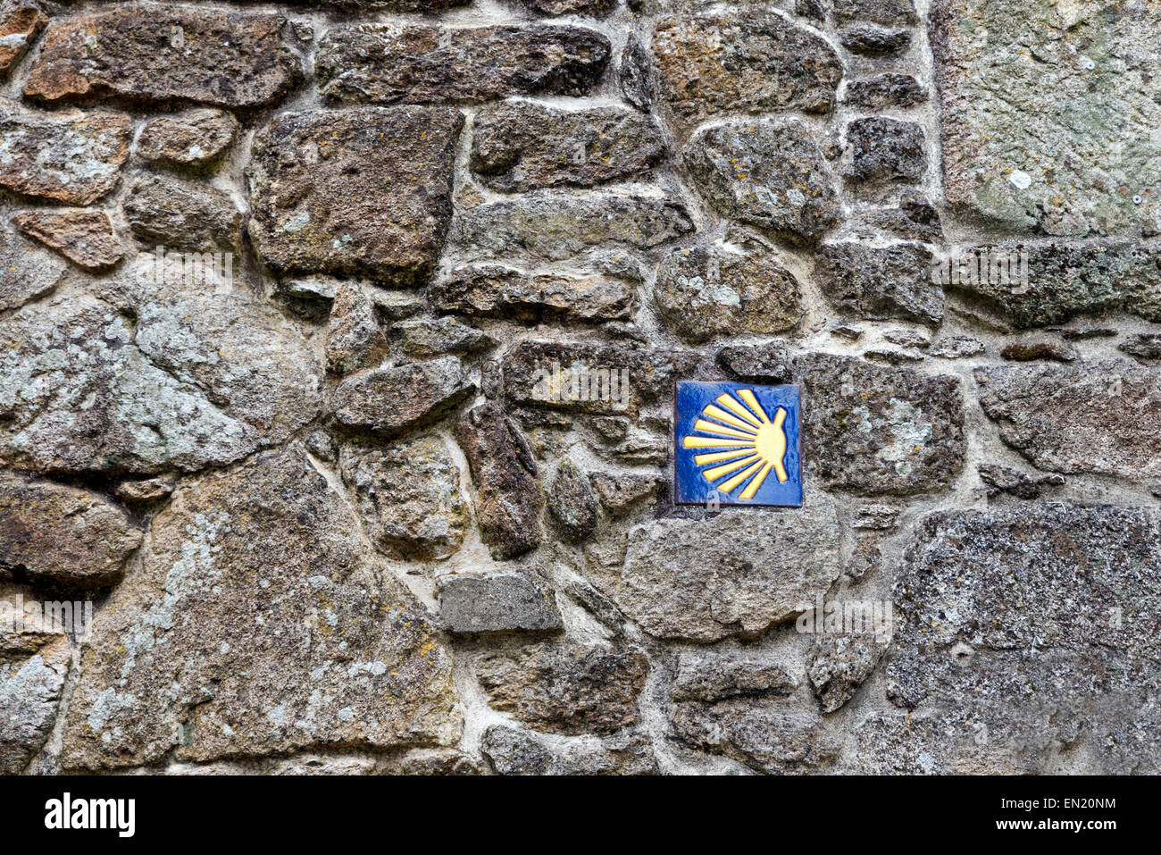 Wegweiser Straße Santiago auf eine Mauer aus Granit. Spanien Stockfoto