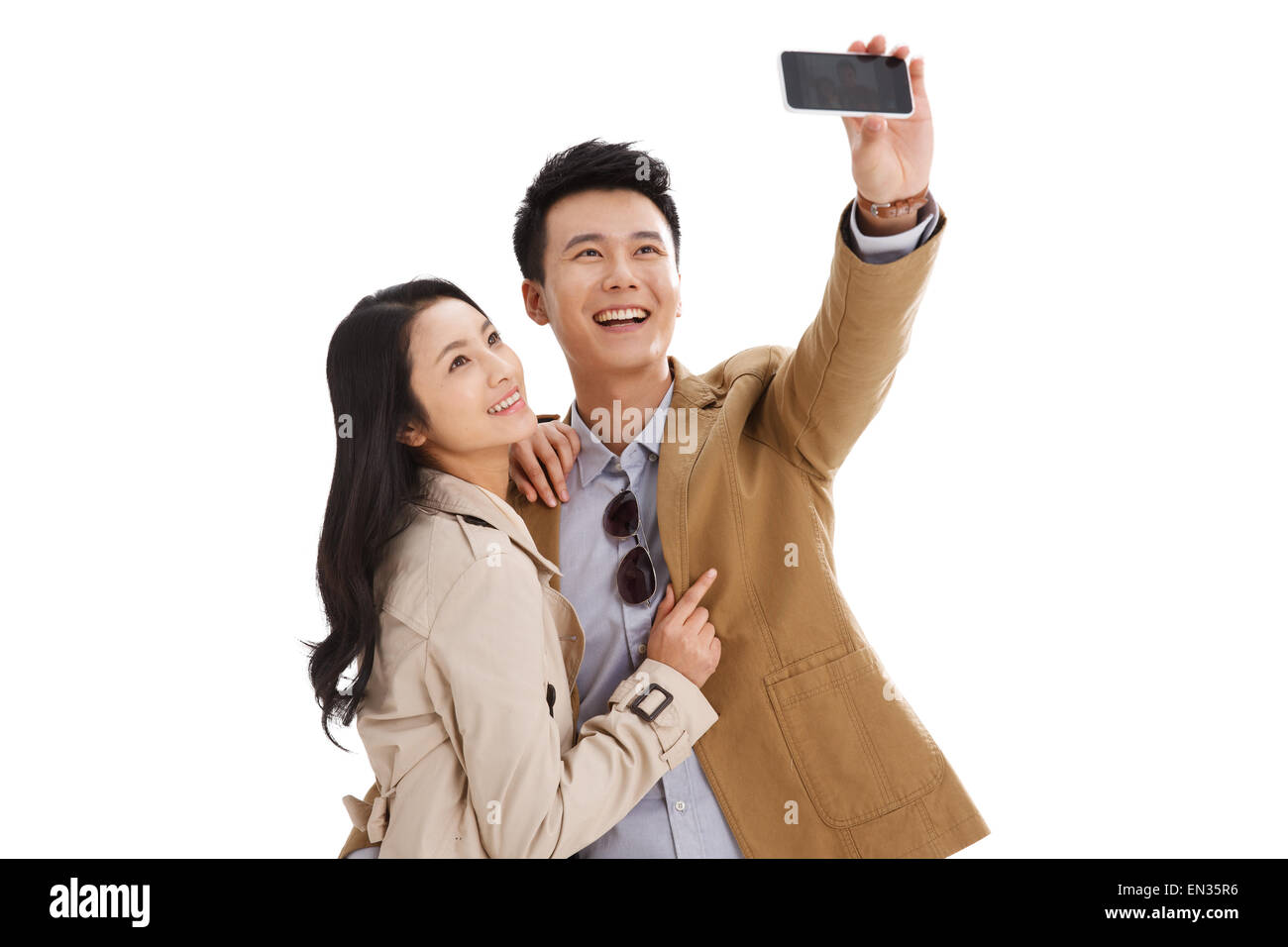 Junge Paare nutzen Handy-autodyne Stockfoto