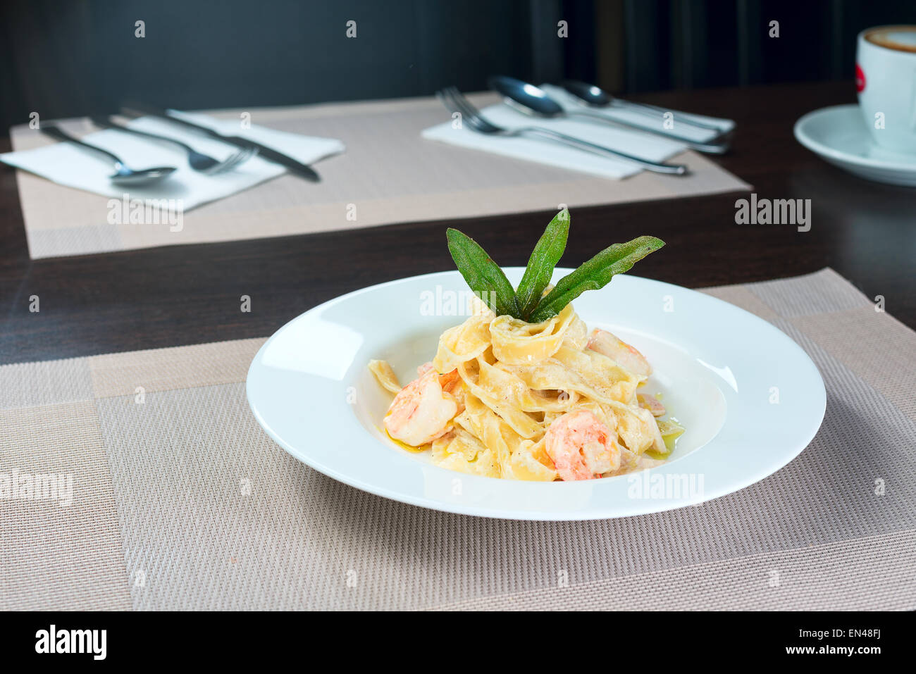 Italienische Pasta mit Garnelen und Basilikum auf einem Teller Stockfoto