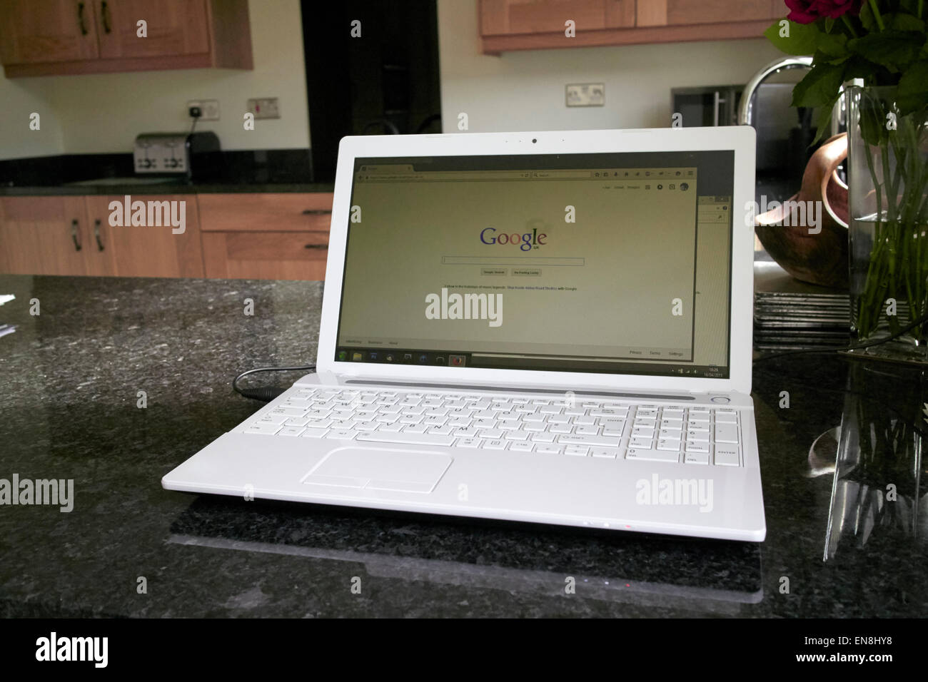 Laptop in der Küche mit Google-Suchmaske, die Arbeit von zu Hause im Vereinigten Königreich Stockfoto