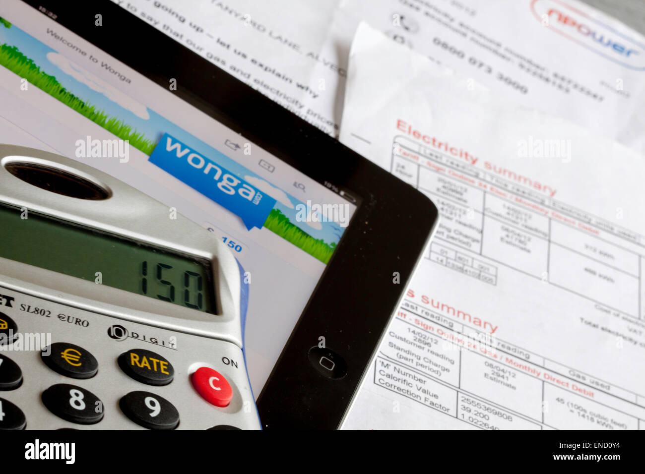 Wonga Darlehen Unternehmens-Website auf einem Ipad mit Taschenrechner und Utility Bills, England, UK Stockfoto