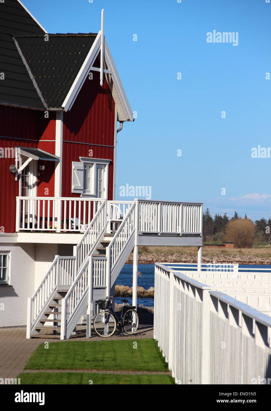 Ferienhaus am See mit Fahrrad und Rasen Stockfoto