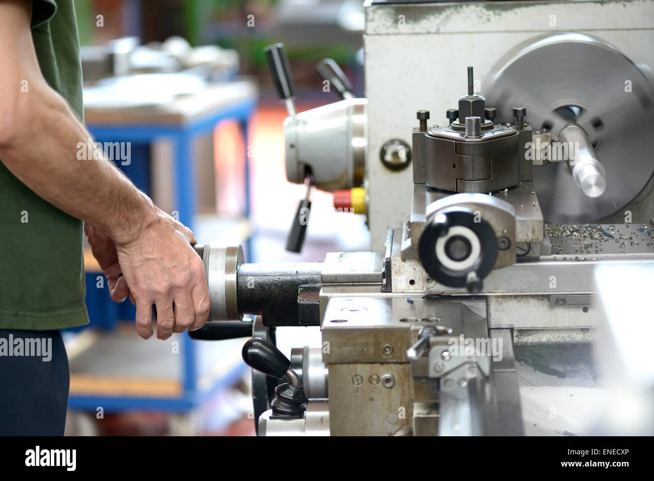 Männliche Blue-Collar Worker tun Handarbeit mit einer Drehbank, industrielle Werkzeugmaschinen für die Metallbearbeitung Stockfoto