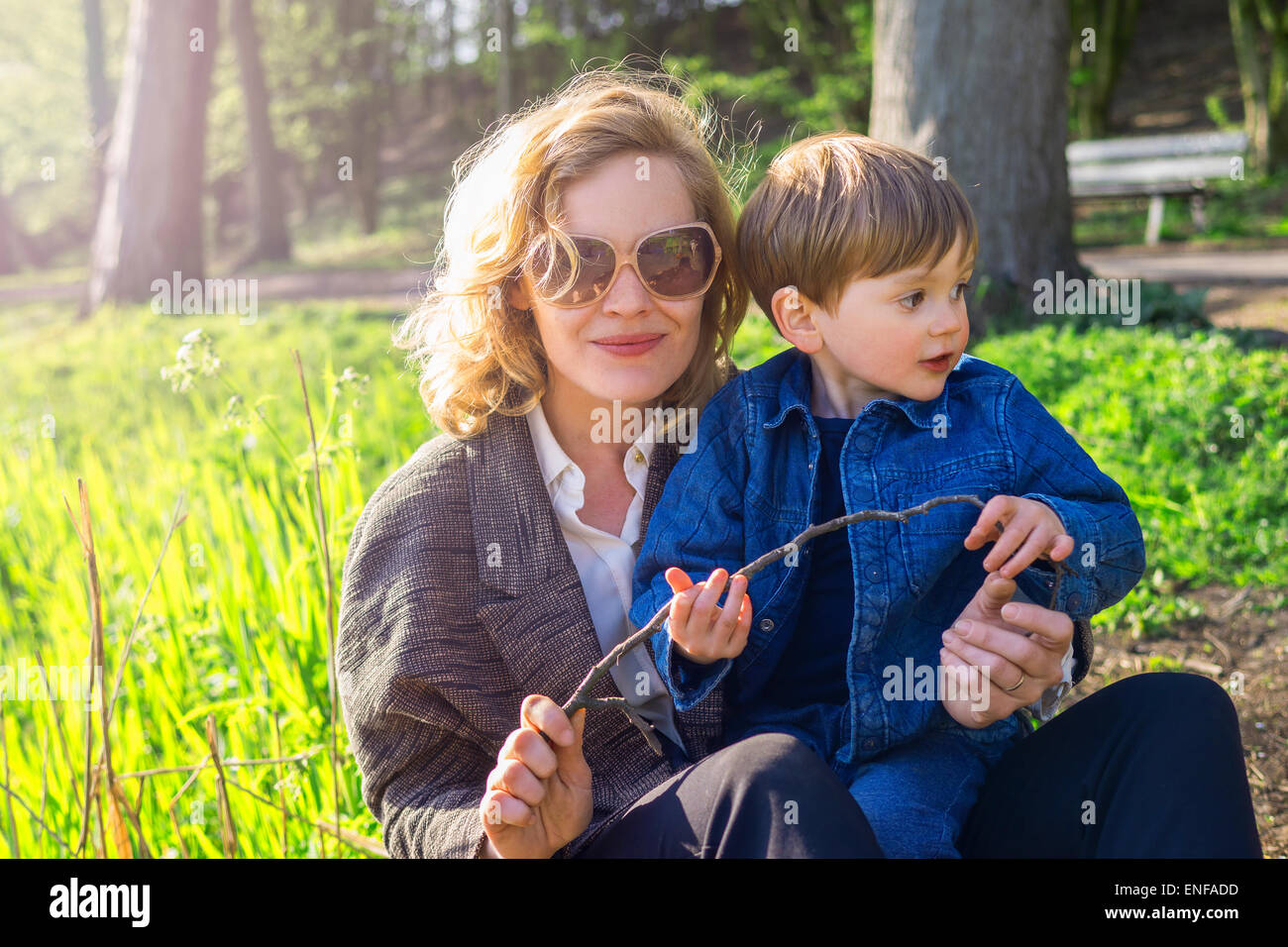 Mutter und Sohn sitzen in einem Stadtpark Stockfoto