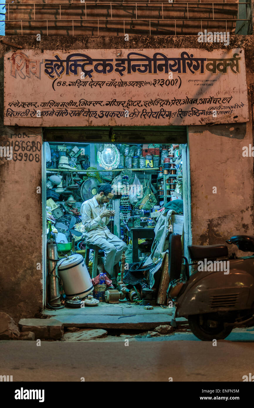 Elektronik-Händler in seiner Werkstatt in den Abend, Udaipur, Rajasthan, Indien Stockfoto