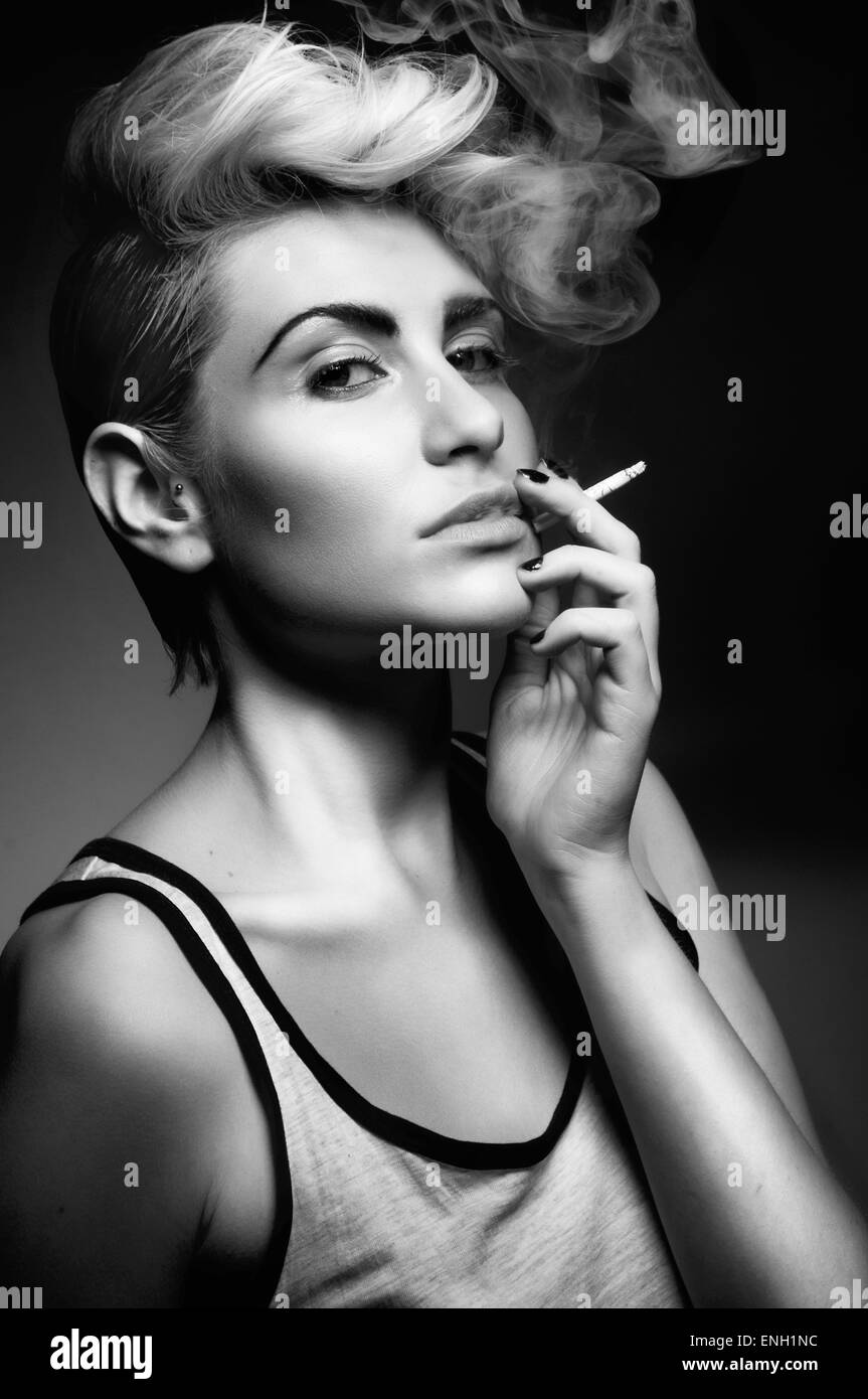 Schwarz / weiß Porträt der jungen Frau raucht eine Zigarette Stockfoto