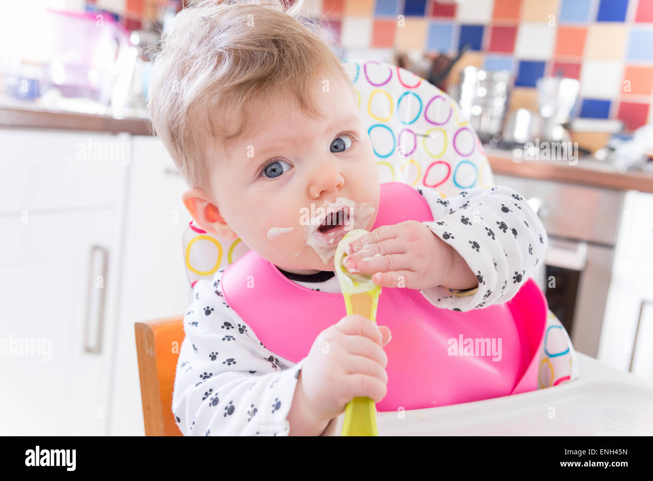 Sechs Monate altes Baby Mädchen Löffel Fütterung auf Brei Stockfoto