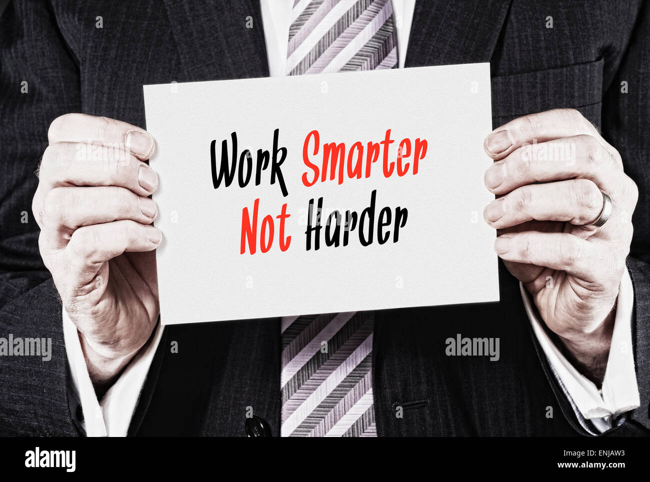 Ein Geschäftsmann hält eine Visitenkarte mit den Worten: Arbeit intelligenter nicht härter. Stockfoto