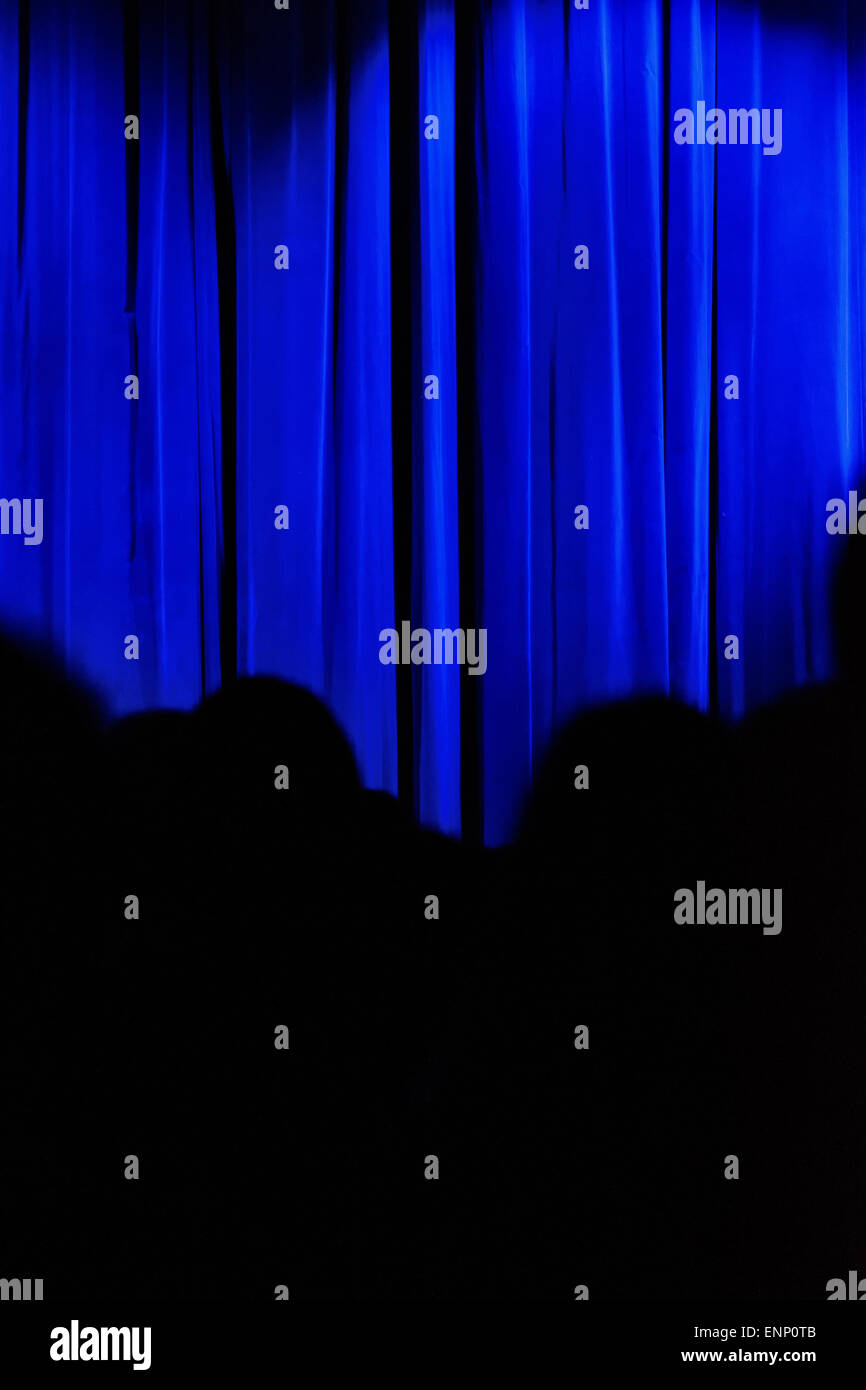 Blauen Vorhang mit schwarzen Silhouetten von Menschen. Stockfoto