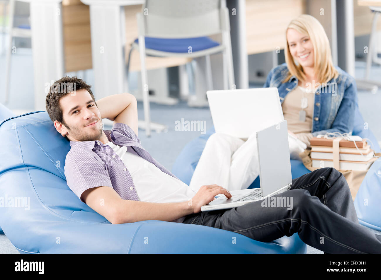 Junge Schüler am Gymnasium entspannen mit laptop Stockfoto