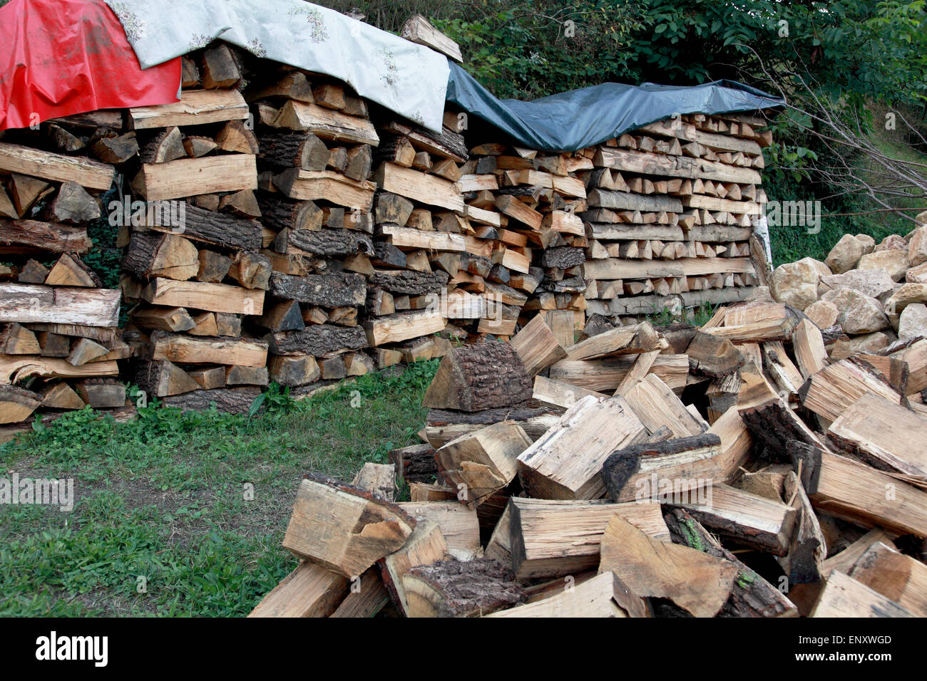Gehackte Holz in einem großen Haufen und gestapelt in Lagerung Haufen mit lose Beläge an der Spitze Stockfoto