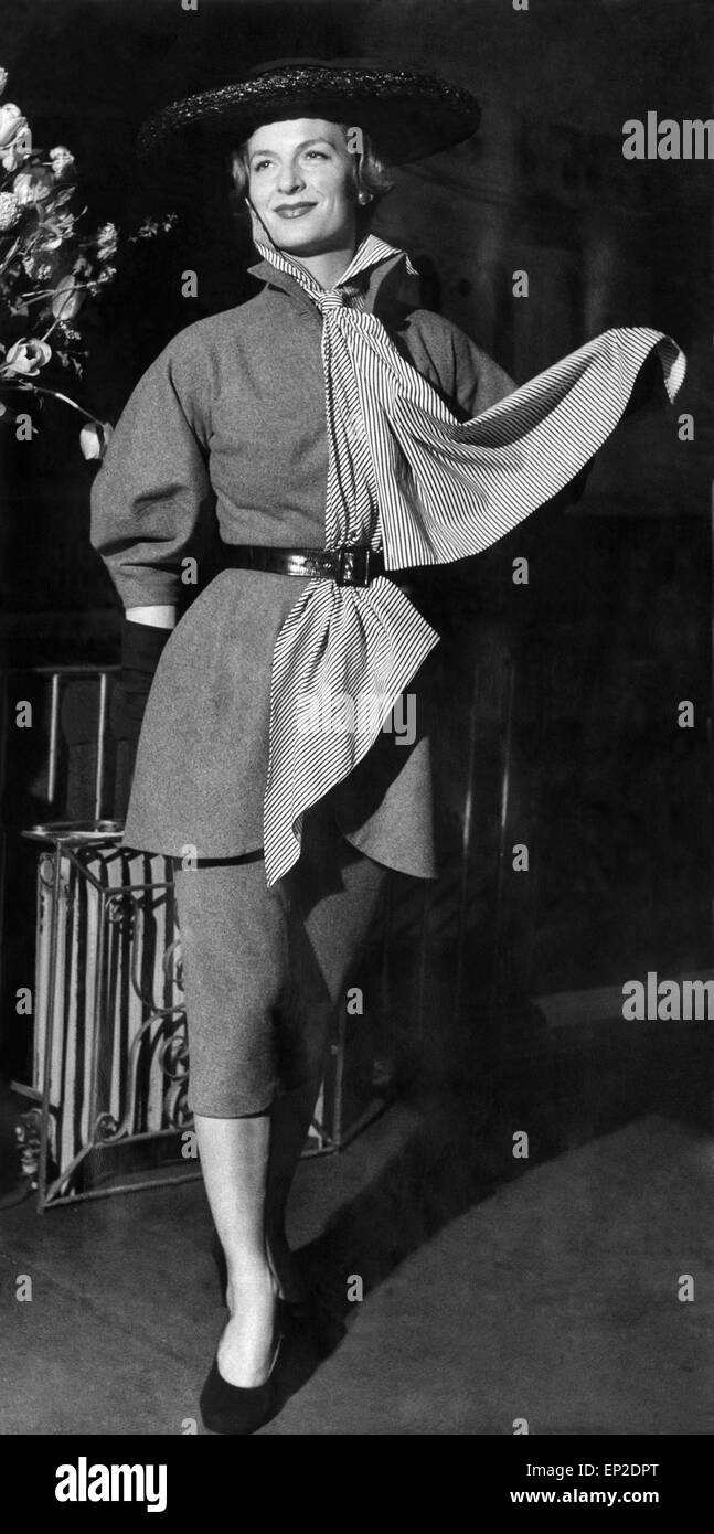 Paris-Frühling und Sommer Mode auf Ciros Club. Für den Frühling im Park oder ein Stadt-Datum... eine grauen Flanell Anzug mit einer extra langen Schal. erlesenen durch einen Strohhut in 1 schwarz. April 1951 Stockfoto