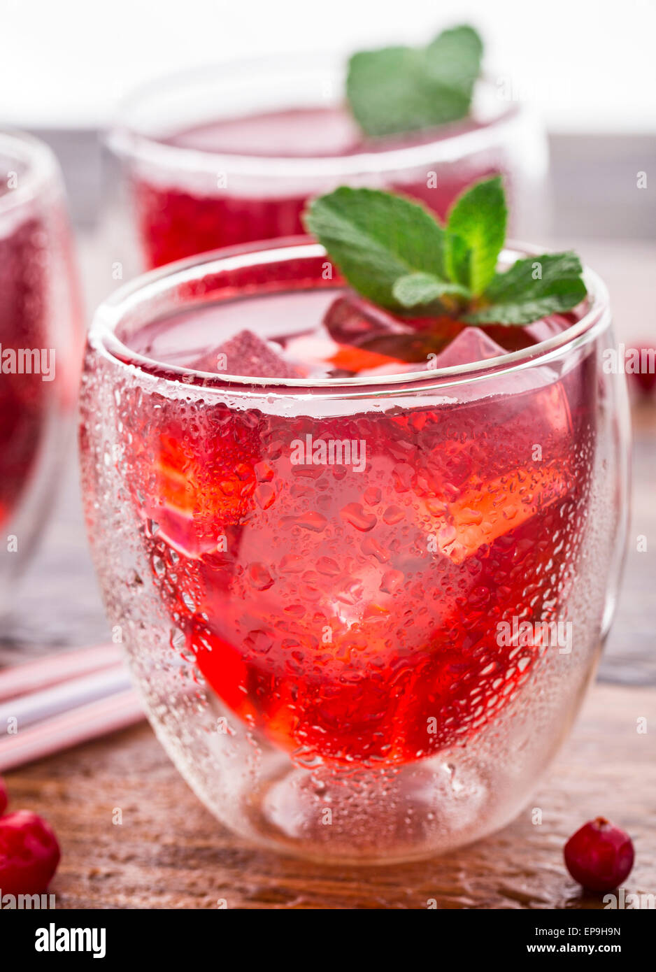 Cranberry-cocktail mit Minze garniert auf einem Holztisch Stockfoto