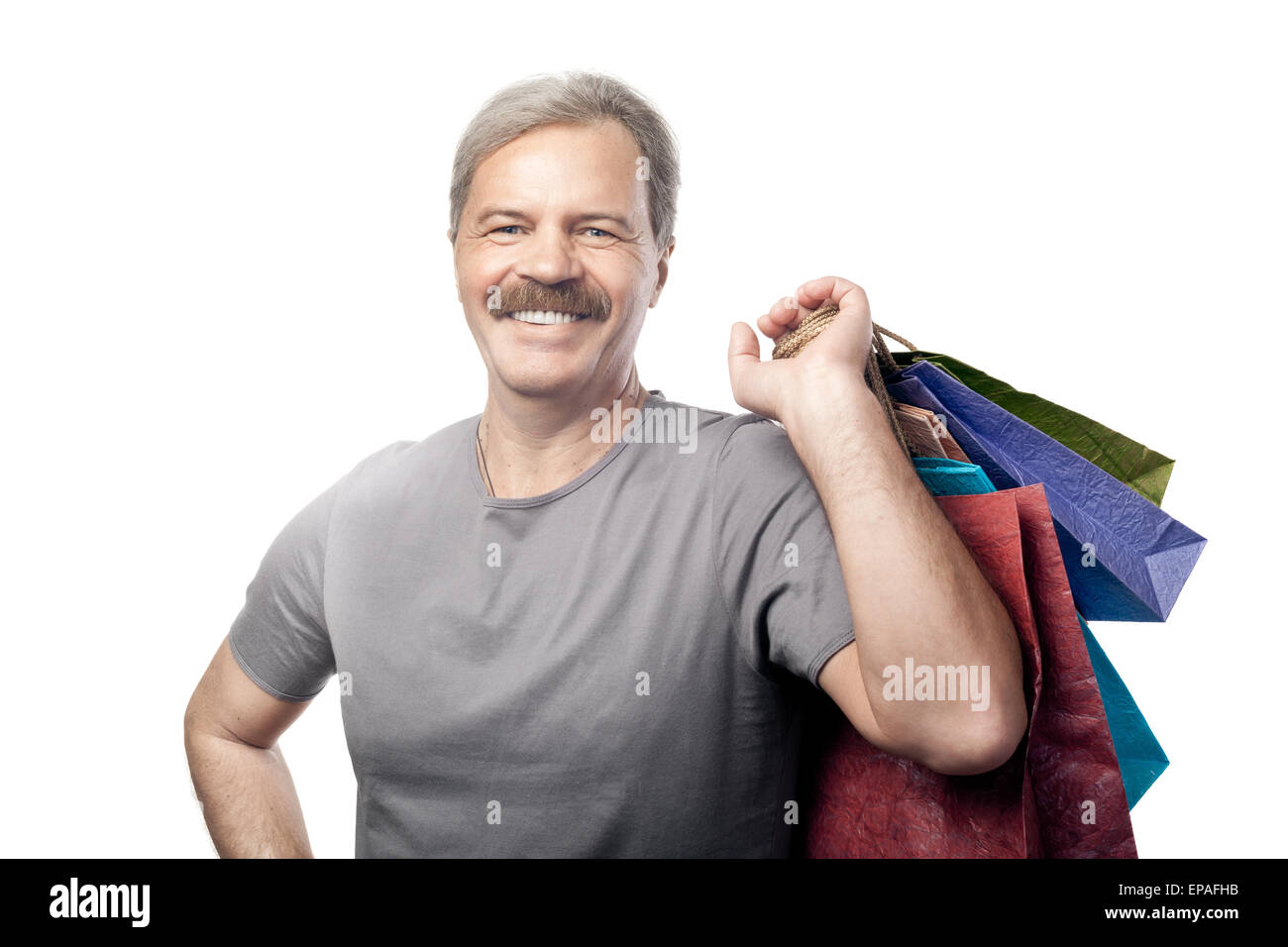 Reifen Mann mit Einkaufstüten isoliert lächelnd Stockfoto