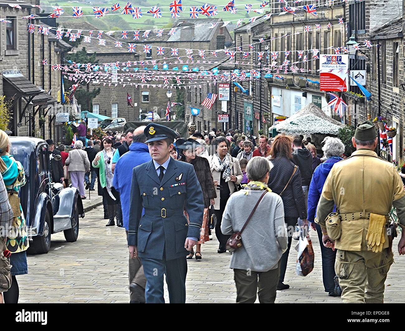 Ein Mann in Militäruniform geht bis Haworth Main Street am 2015 1940s Wochenende am Samstag 16. Mai 2015 Stockfoto