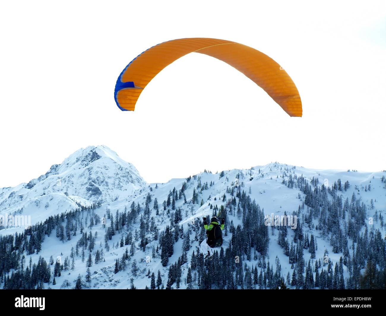 Gleitschirm mit verschneiten Bergen im Hintergrund. Stockfoto