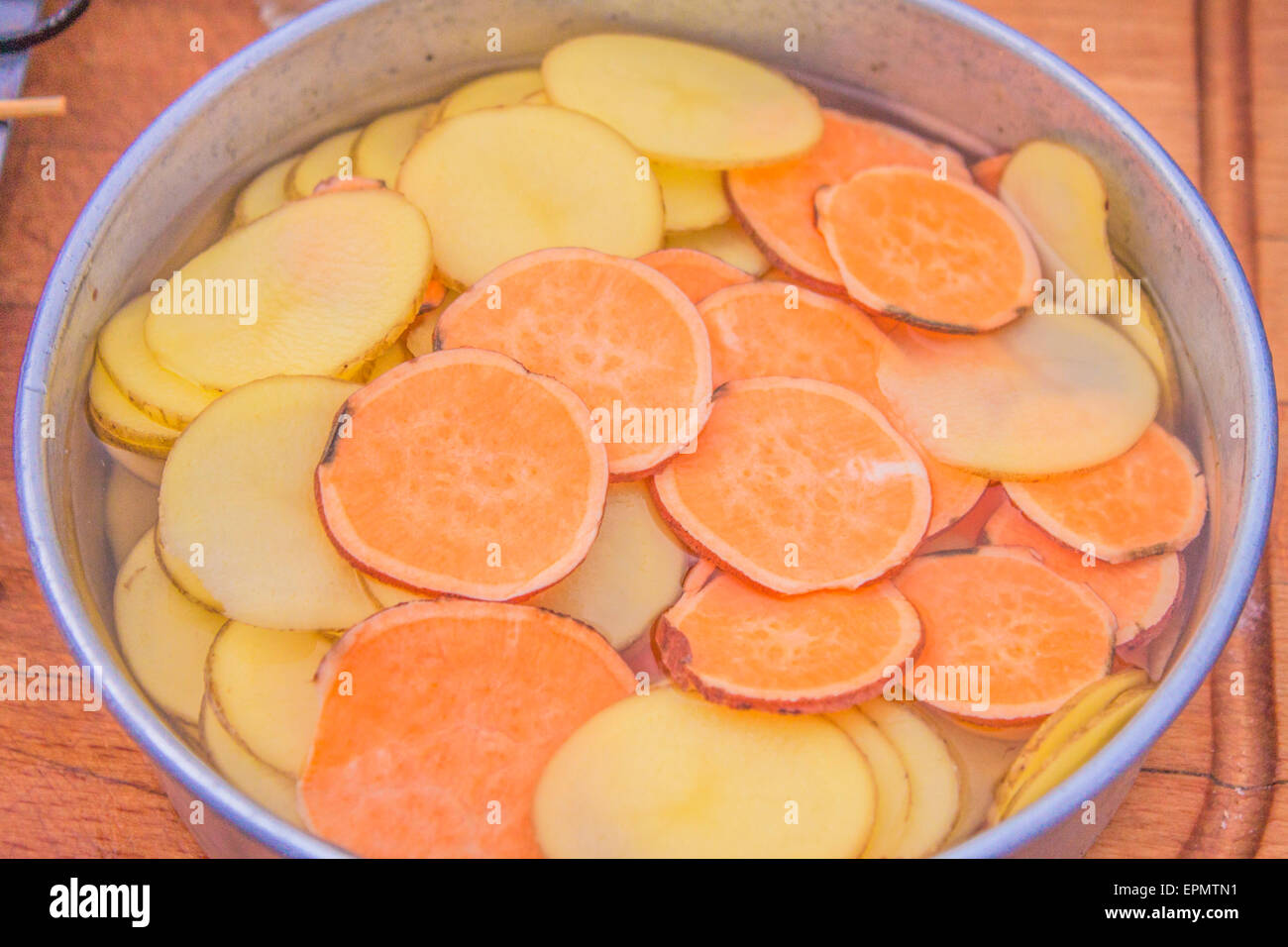 Kartoffeln und Süßkartoffeln Scheiben im Wasser Stockfoto