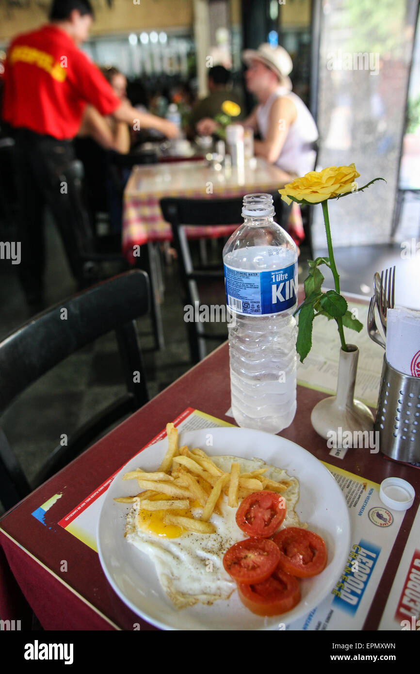 Gebratene Eiern und chips westliches Essen im Leopold Cafe, die von Terroristen angegriffen wurde. Sehr beliebt bei Rucksacktouristen / budget Touristen. In der Nähe von The Taj Hotel, vier Monate nach terroristischen Angriff auf diese Stadt in Coloba Bereich von Mumbai / Bombay, Indien Wirtschaftsmetropole und Hauptstadt des Bundesstaates Maharashtra, Indien, Asien. Stockfoto