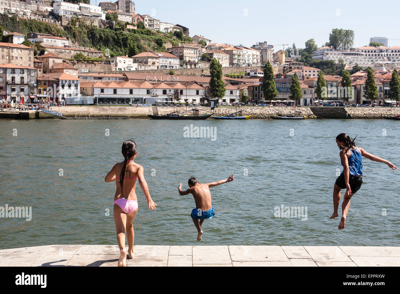 Im Stadtteil Ribeira, das mittelalterliche Viertel am nördlichen Ufer des Douro Flusses. Einheimischen Tauchen in den Fluss zum Spaß und als Foto aufgenommen im Juli mit 42 Grad Lufttemperatur abkühlen lassen. Porto, auch bekannt als Porto ist die zweitgrößte Stadt in Portugal. Liegt an der Mündung des Flusses Douro im Norden Portugals, Porto ist eines der ältesten europäischen Zentren und als Weltkulturerbe von der UNESCO eingetragen. Porto, Portugal. Stockfoto