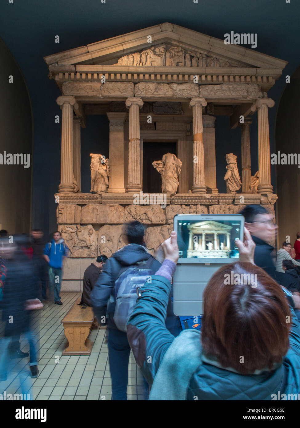 Besucher, die eine Aufnahme eines griechischen Tempels mit einem Tablet im British Museum Stockfoto
