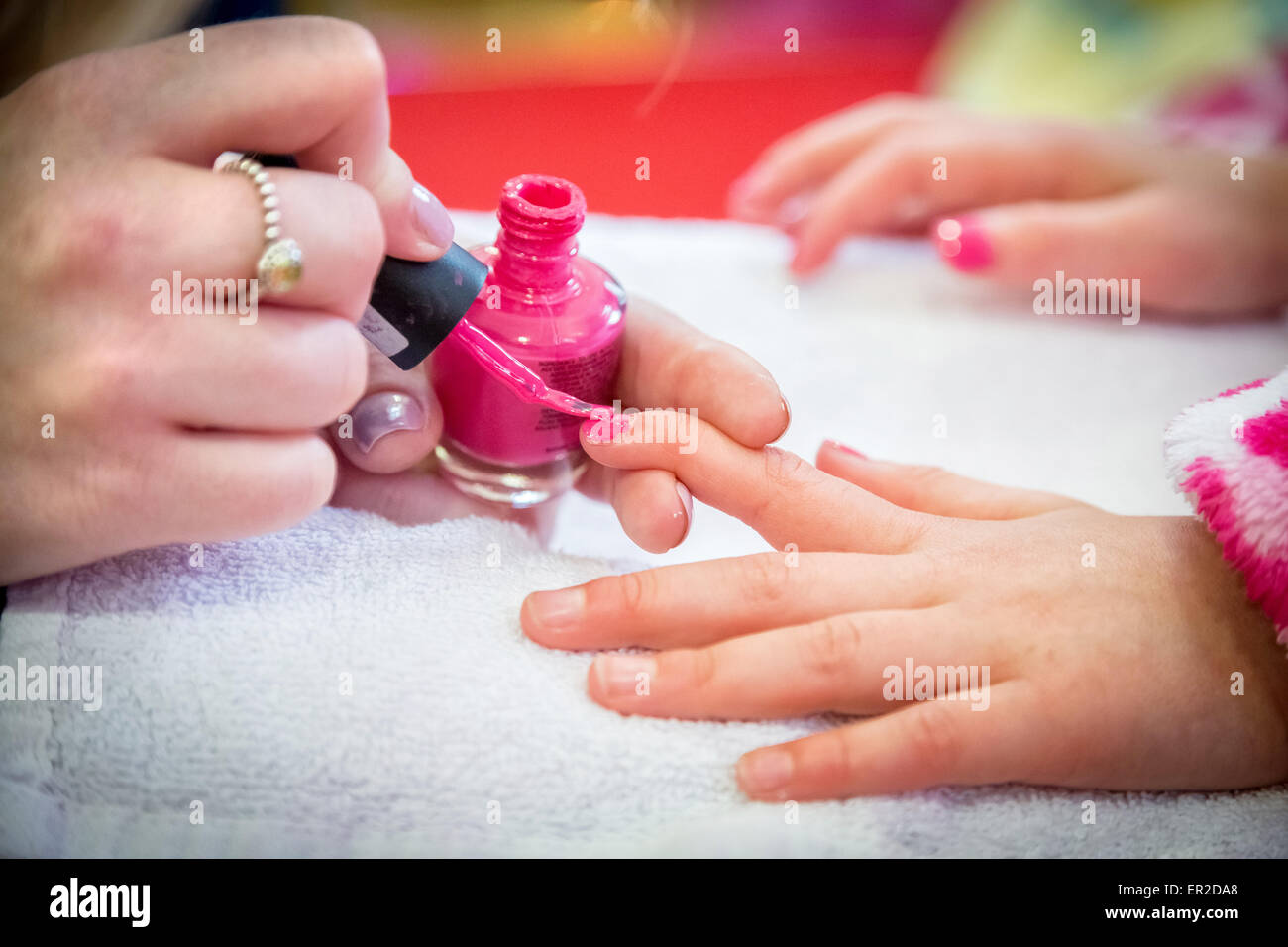 Kleines Kind erhält Nagellack während einer Schönheitsbehandlung für Maniküre/Spa-Tage Stockfoto