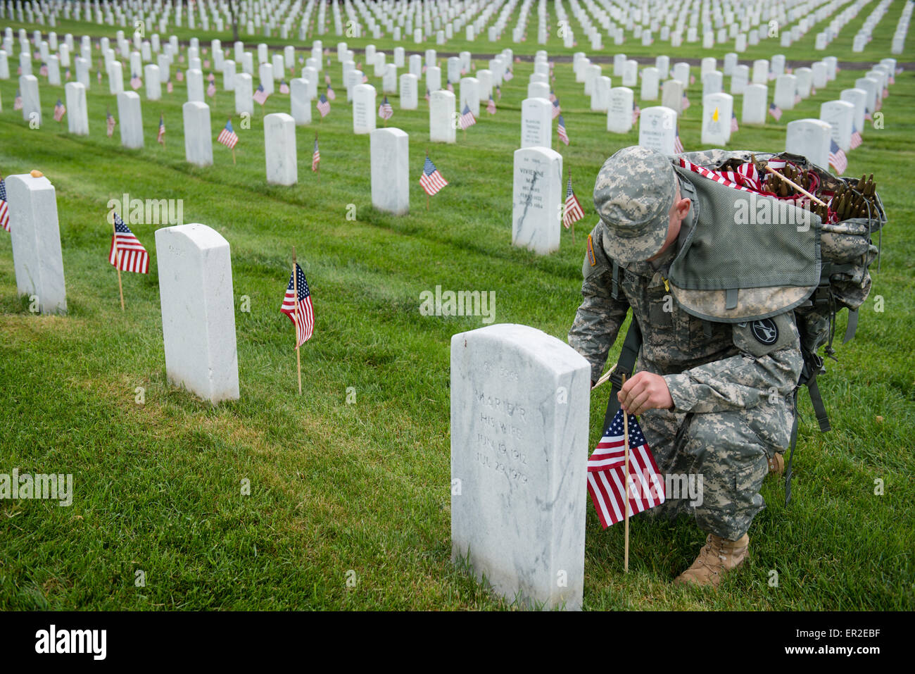 Ein Soldat der US Army aus der alten Garde legt Flaggen vor Grabstätten zu Ehren des Memorial Day auf dem Arlington National Cemetery 21. Mai 2015 in Arlington, Virginia. Die alte Garde dirigierte Flaggen-in, wenn eine amerikanische Flagge befindet sich bei jedem Grabstein seit 1948. Stockfoto