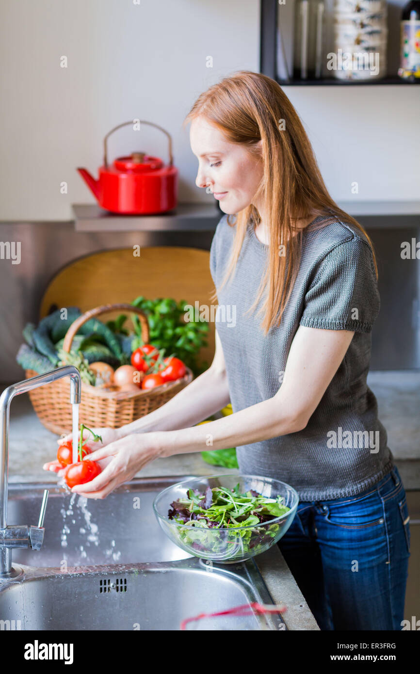 Frau waschen Gemüse. Stockfoto