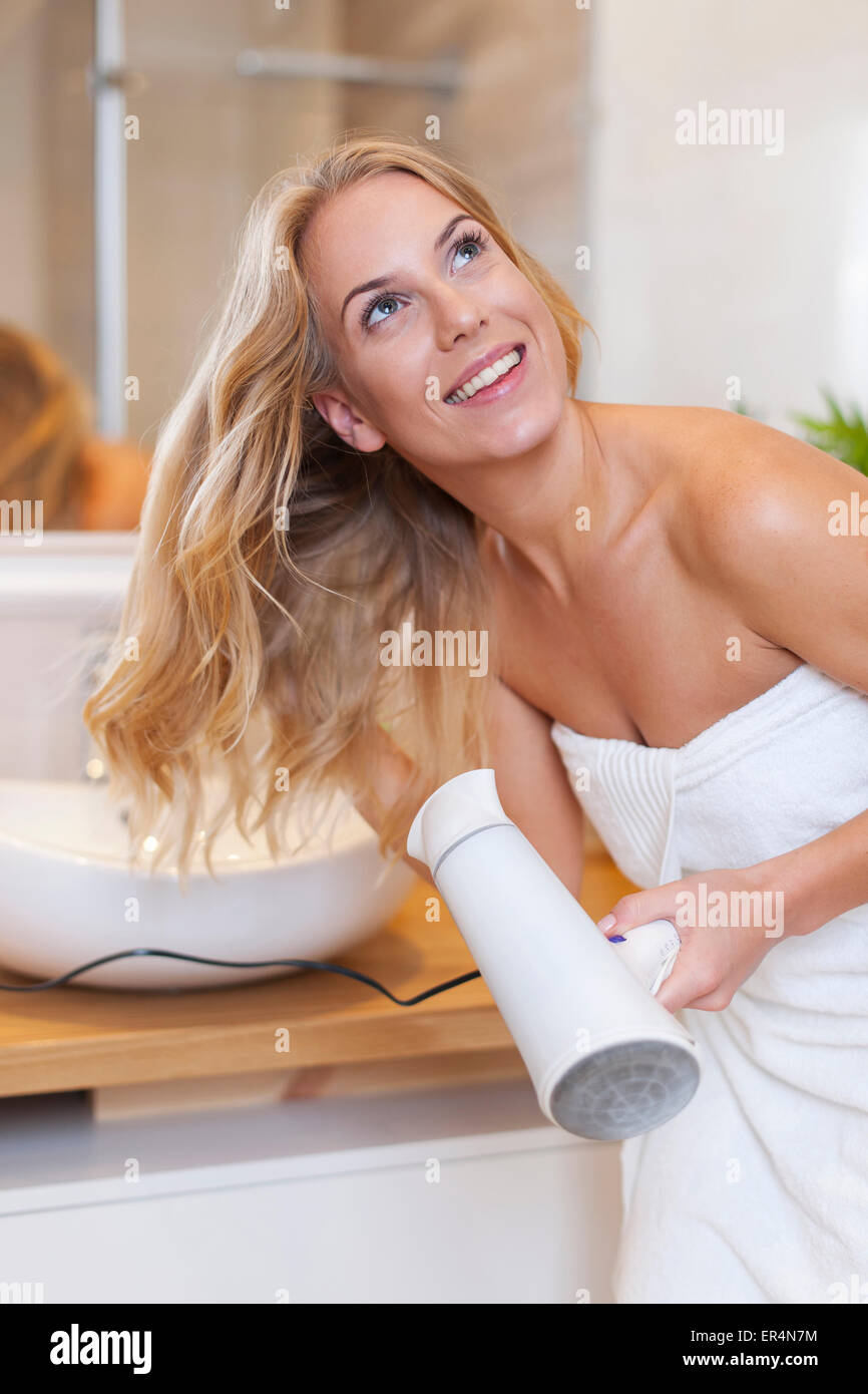 Blonde Frau trocknen Haare nach dem Duschen. Debica, Polen Stockfoto