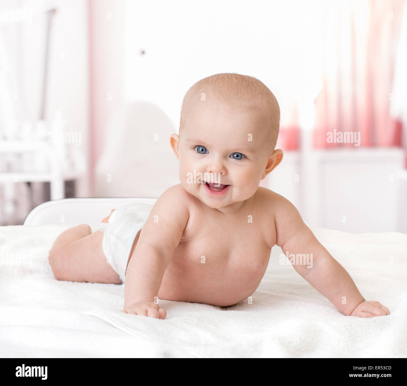 gesundes, glückliches Baby auf Bett liegend Stockfoto